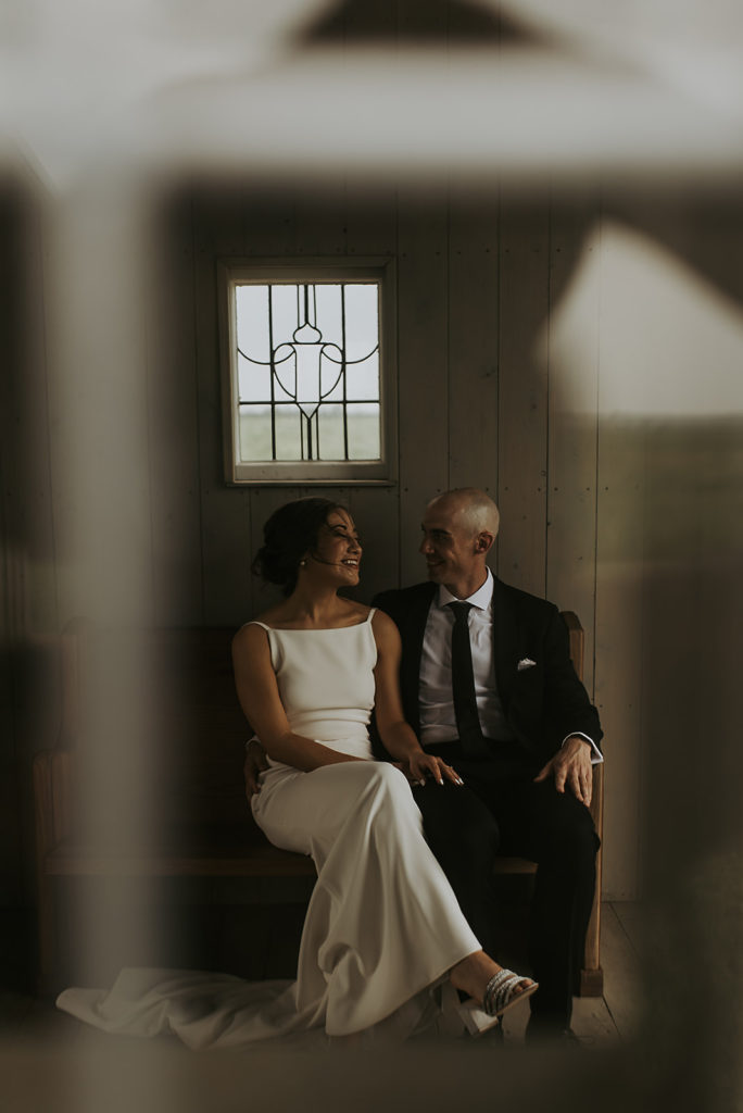 bride and groom sitting in allen farmhaus