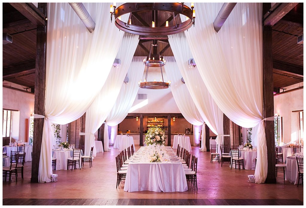 wedding reception with white draping and head table