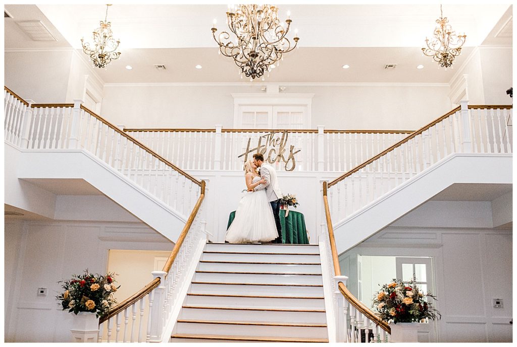 bride and groom grand entrance at the top of the stairs at kendall point