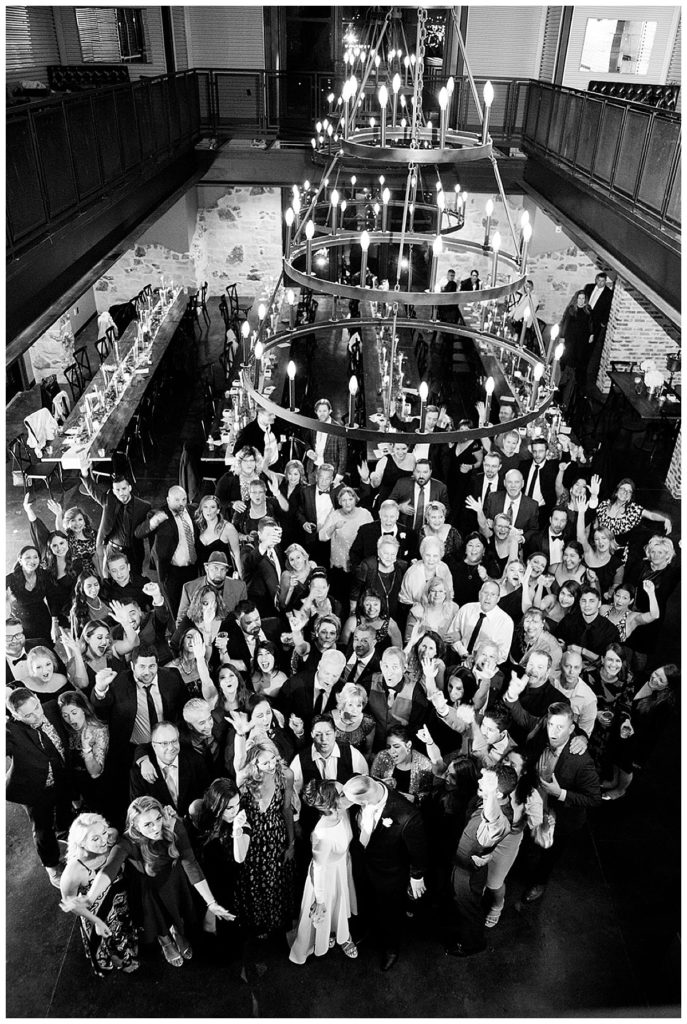 black and white image of all guests at wedding reception