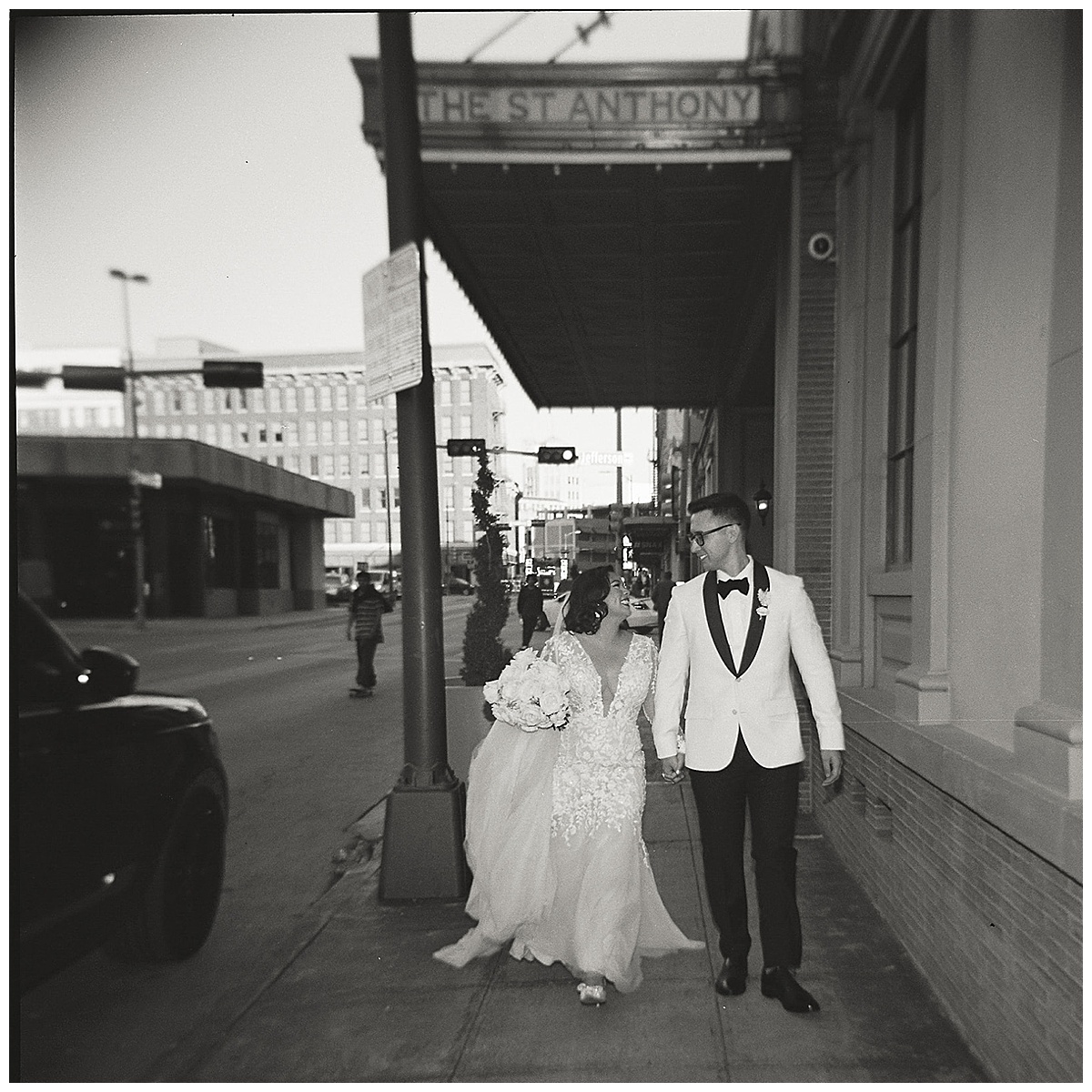 bride and groom black and white photo in front of St. Anthony hotel