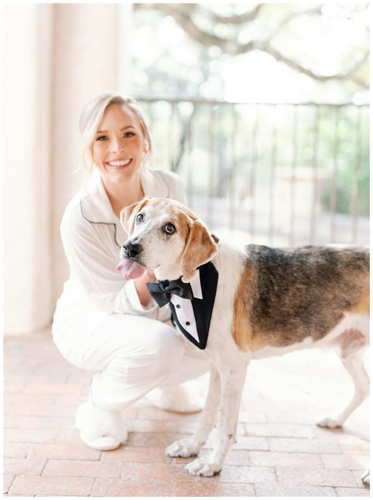 bride poses with dog on wedding day